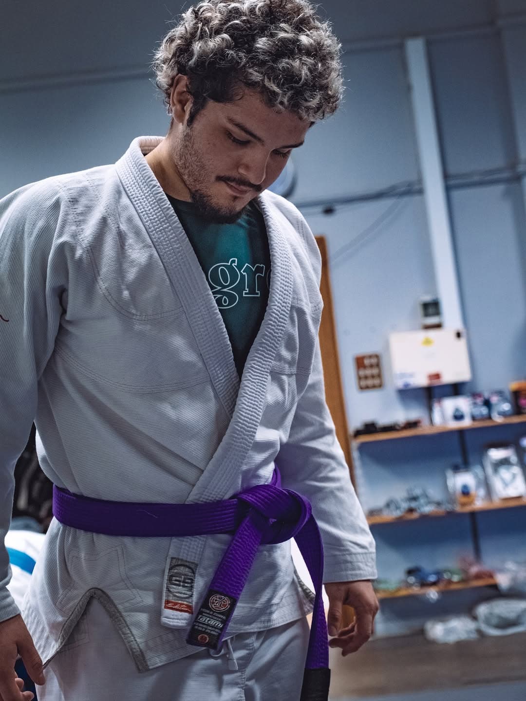 A member tying their belt at the academy
